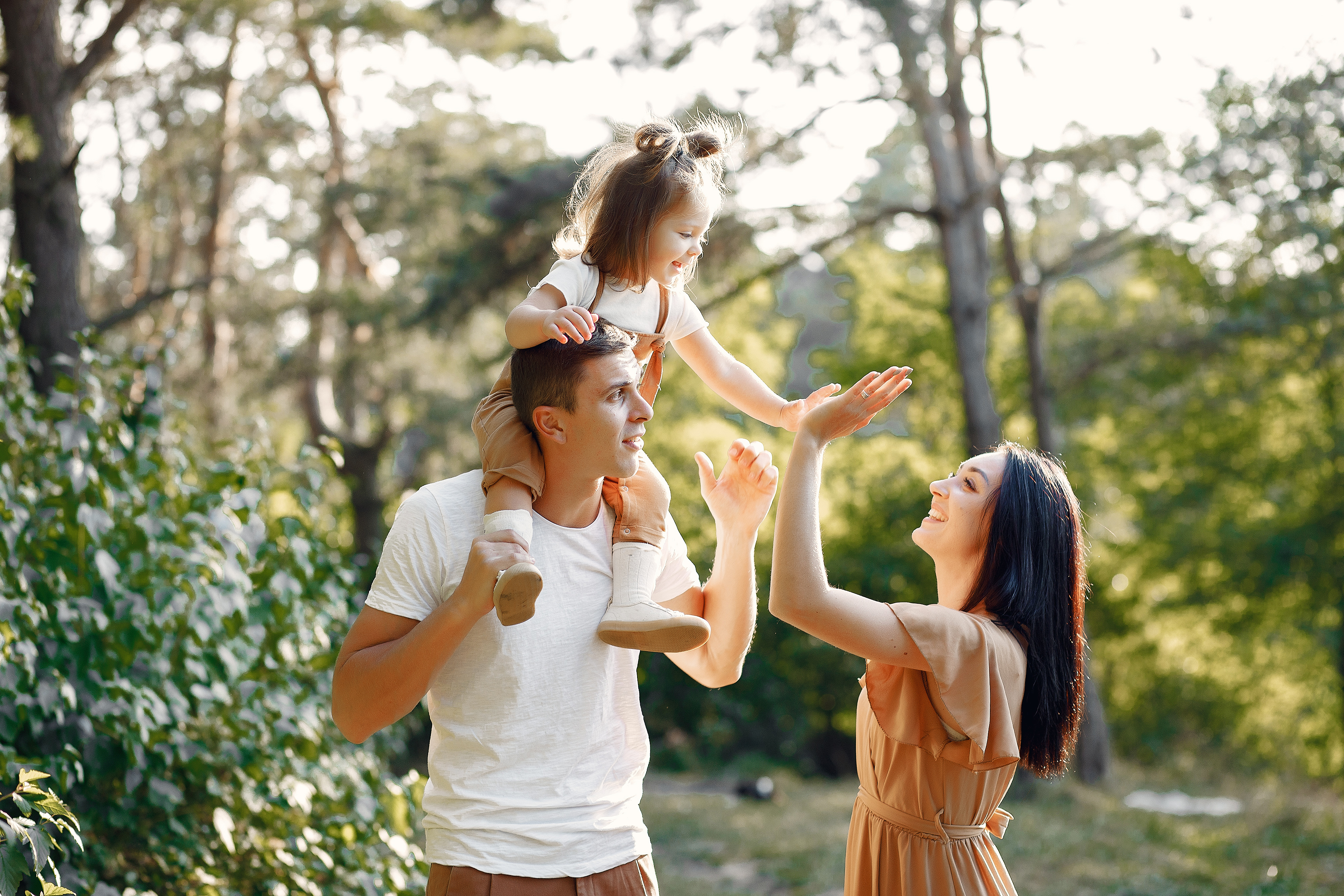 Family enjoying time outside in a sunlit park